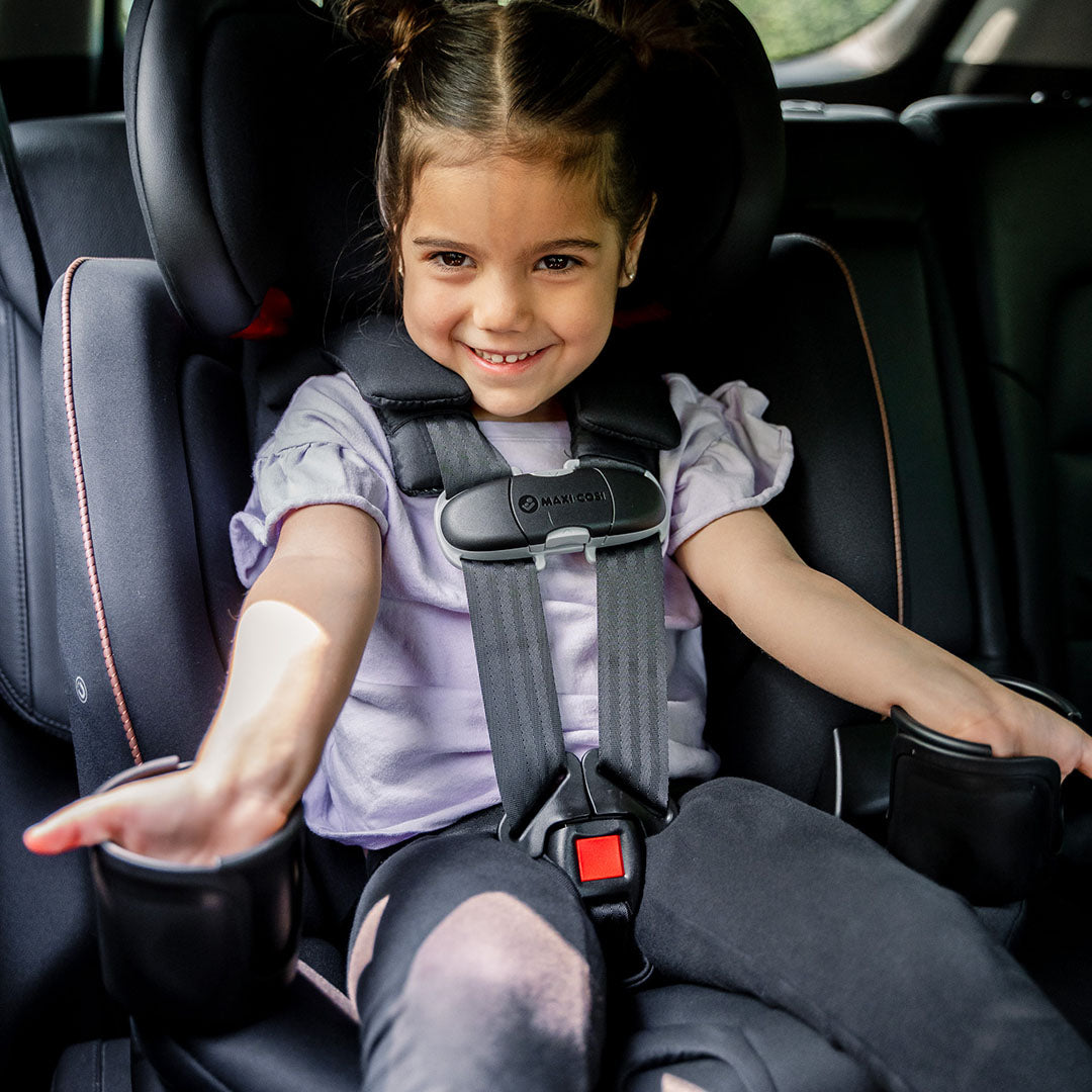 Maxi-Cosi Andi 360 rotating convertible car seat in dark gray with child strapped in harness