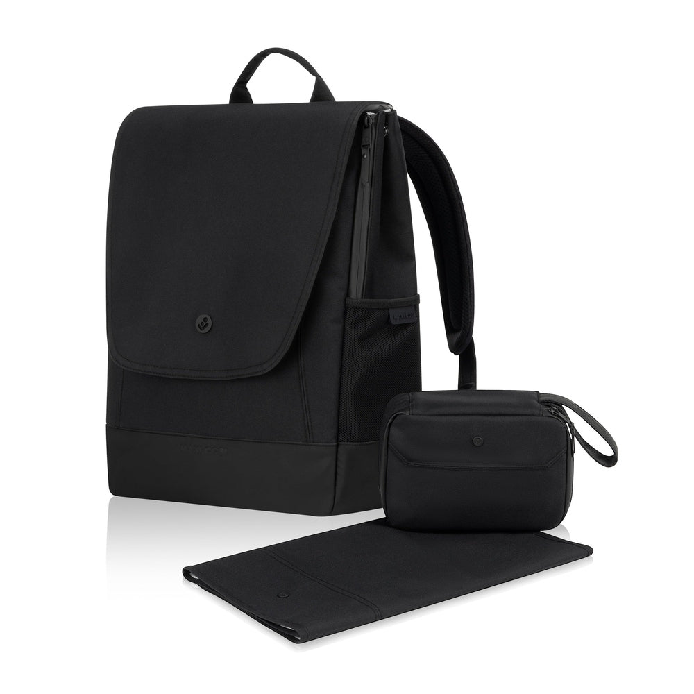 Maxi Cosi Changing Backpack in black, showing front flap, side pocket, and included pouch and changing mat.
