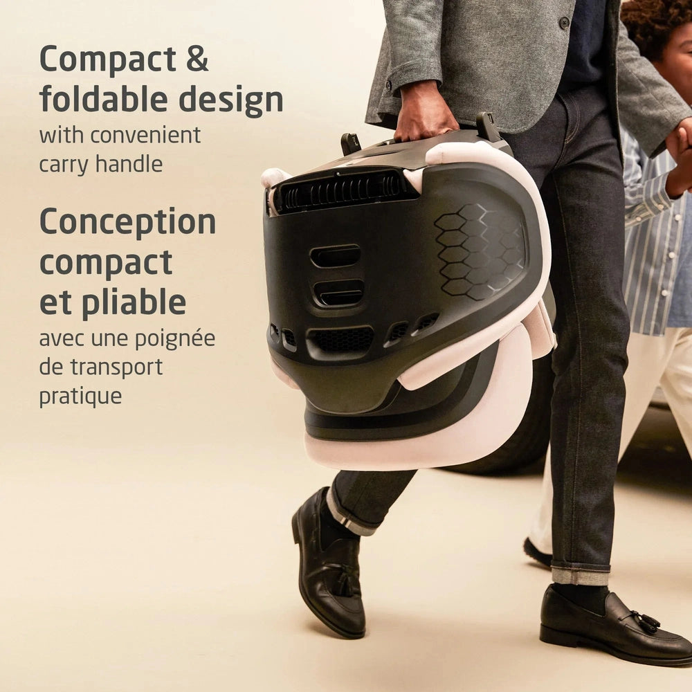 MAXI COSI Tanza Belt-Positioning Booster Car Seat, compact foldable design with carry handle, being carried by an adult.