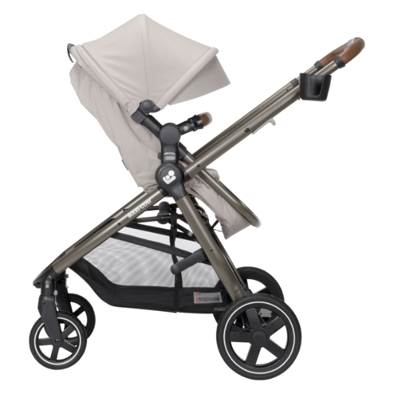MAXI COSI Zelia Luxe 5-In-1 travel system stroller in beige with extended canopy, adjustable handle, and under-seat storage.