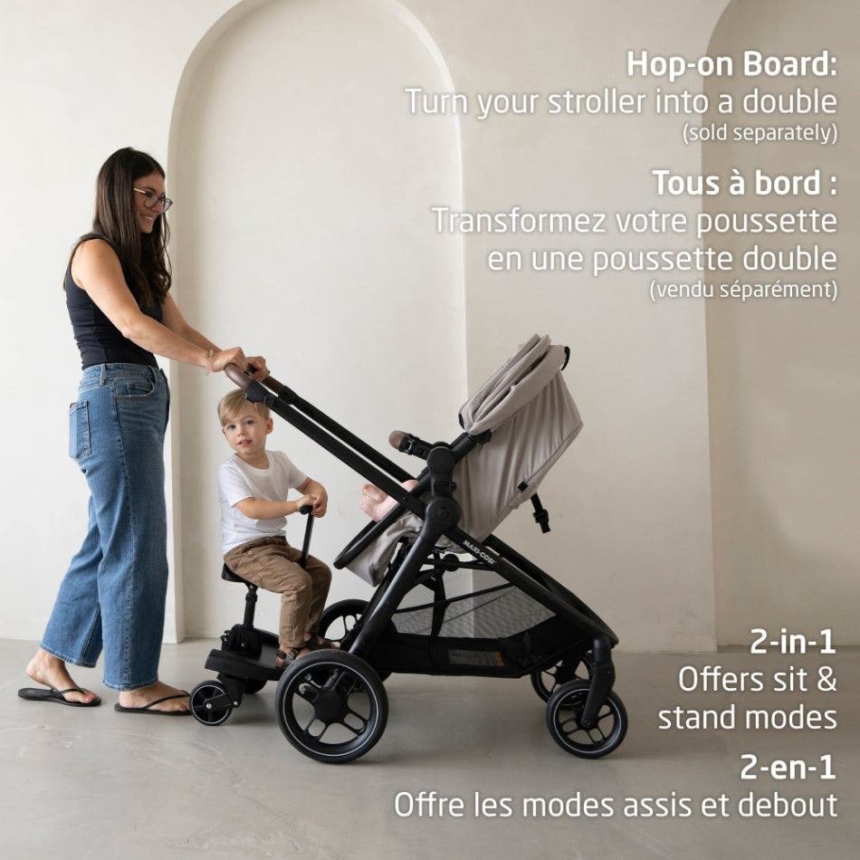 Maxi-Cosi Zelia Luxe 5-in-1 modular travel system in black frame; mom pushes with child seated.