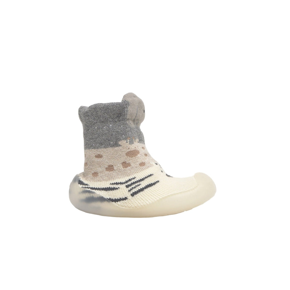 Mayoral newborn baby slipper socks in grey and cream knit with a flexible sole, shown on a tiny foot