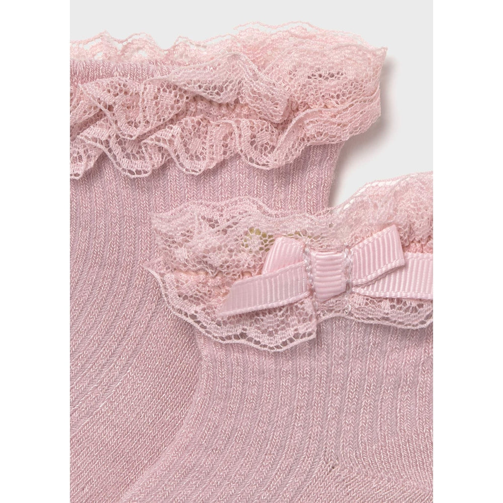 MAYORAL Newborn dress socks Baby Rose Pink with lace trim and bow, shown on soft ribbed knit fabric.