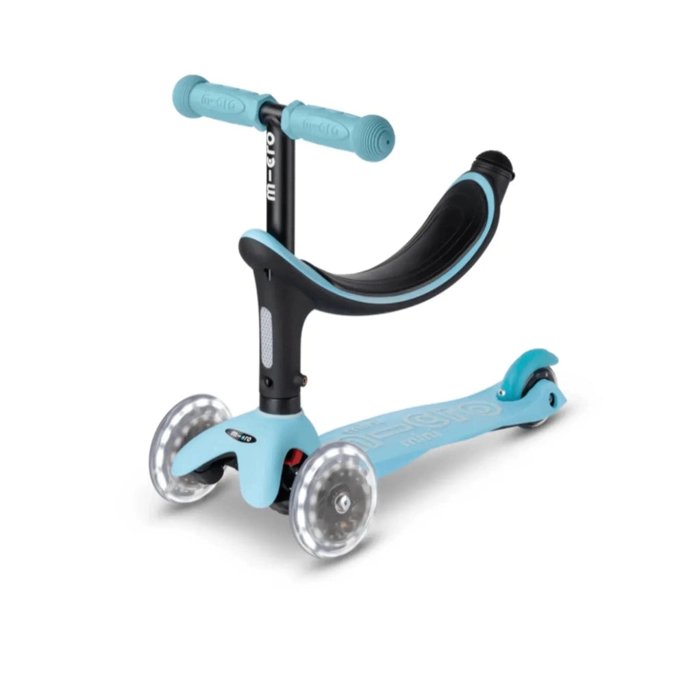 Micro Mini2Grow Deluxe LED Scooter: blue deck, black stem, clear LED wheels rolling.