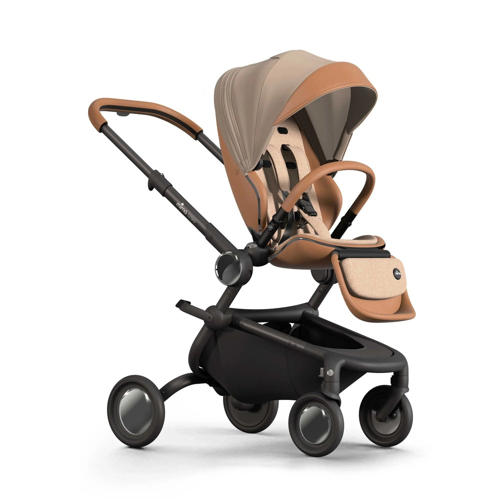 Mima Creo Stroller in tan beige with black frame; canopy raised and seat secured for stroll.