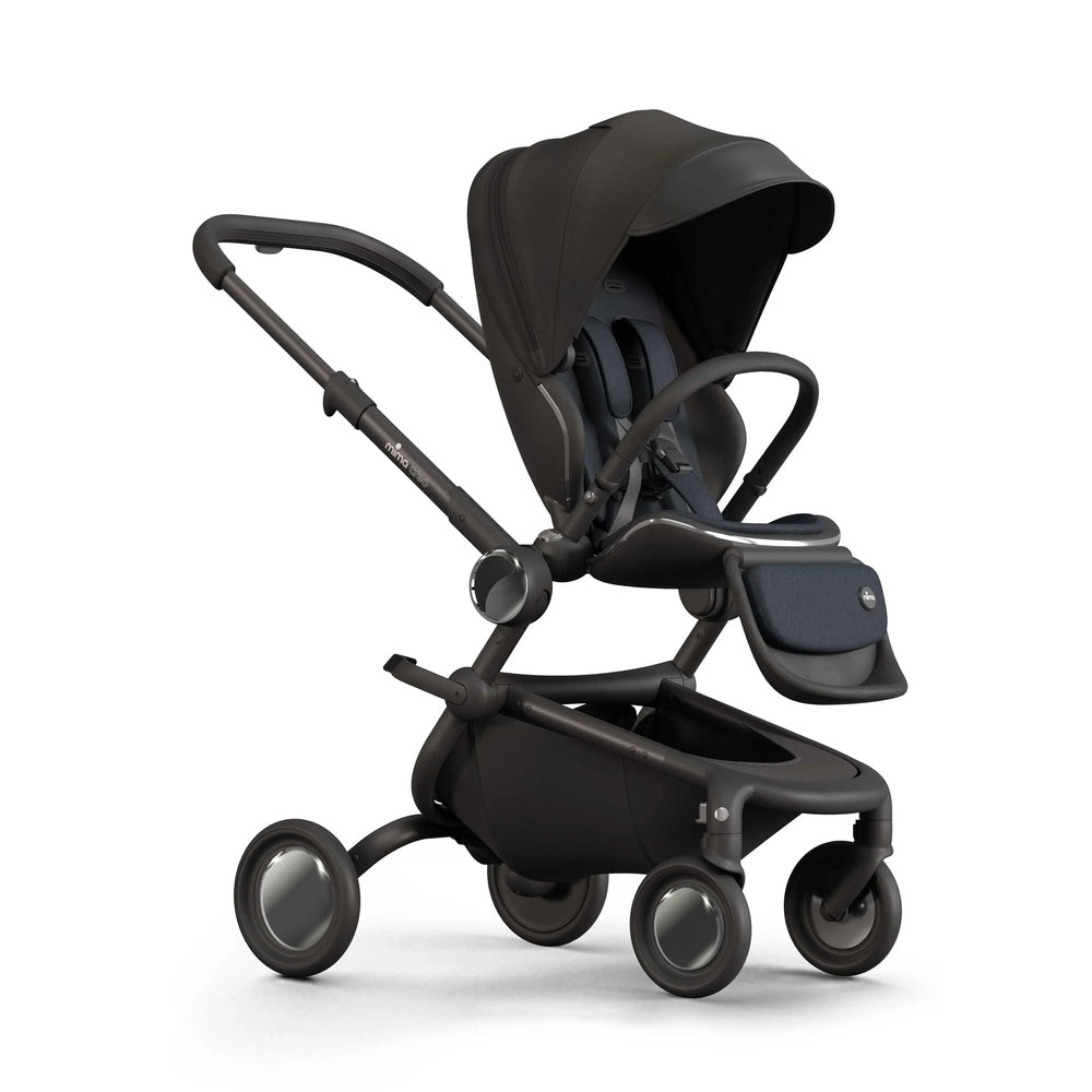 Mima Creo Stroller in black with full canopy and integrated seat, shown on a 4-wheel chassis ready for a stroll