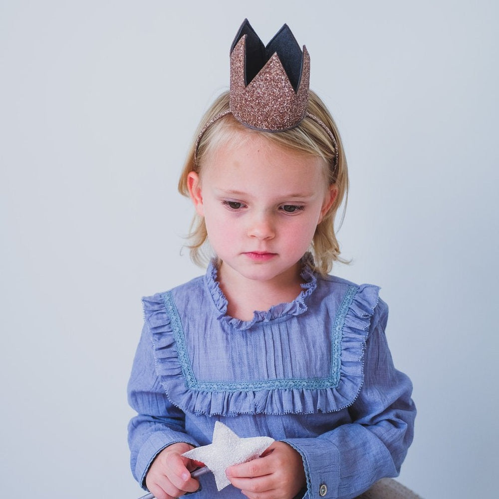 Mimi & Lula Glitter Crown Alice Gold headband on a young girl wearing a blue dress