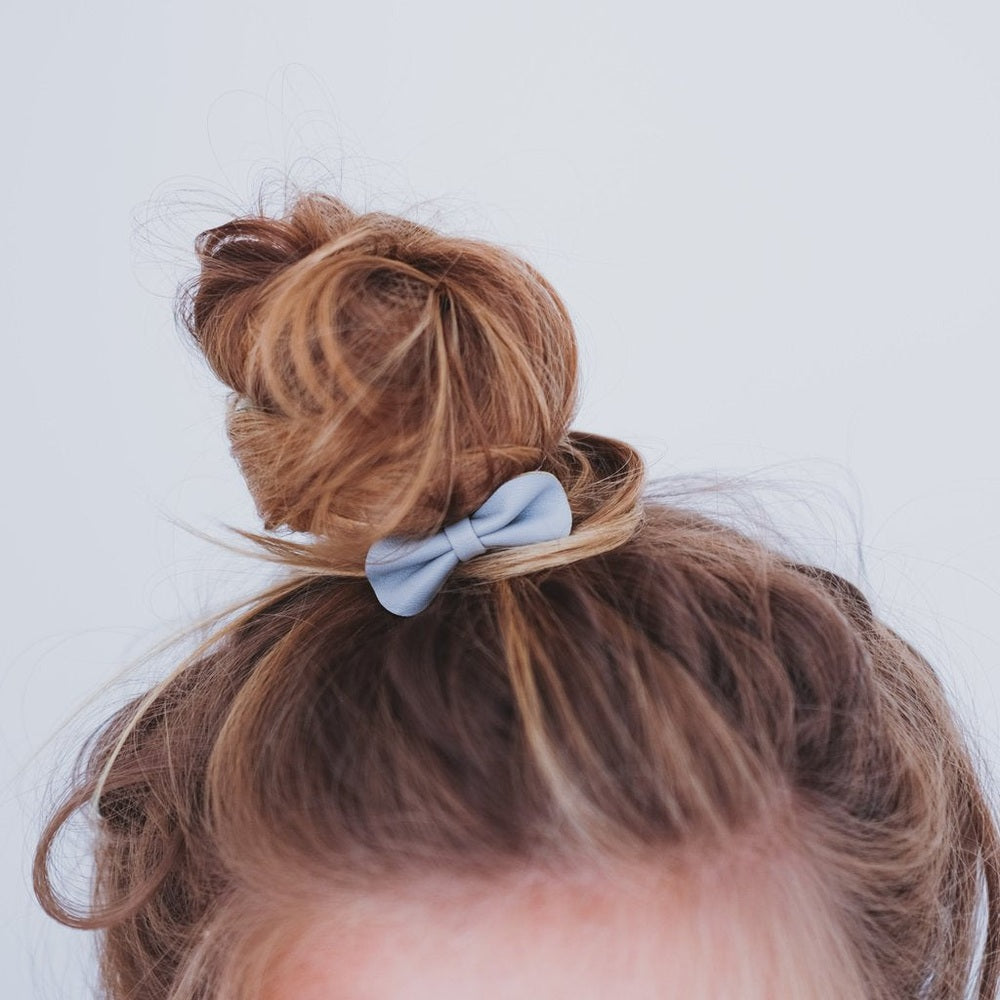 Mimi & Lula Gracie Ponies Pink hair accessory; light blue scrunchie tied in a bun