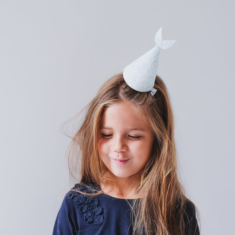 Mimi & Lula Mermaid Hat Blue worn by a girl, glittery cone with fin detail