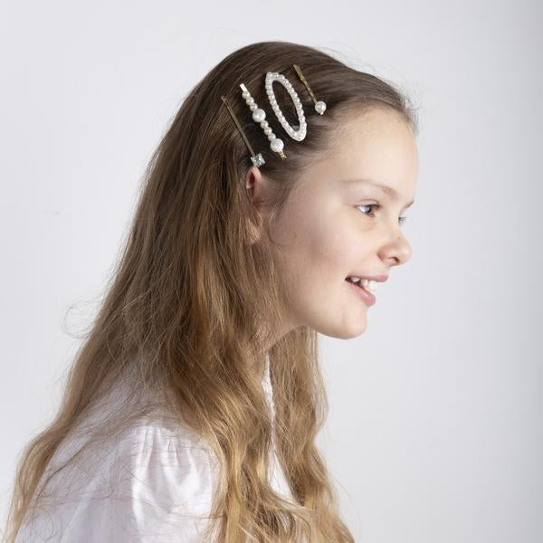 MIMI & LULA Pearly Queen Kirby Grips pearl hair clips on a smiling girl

