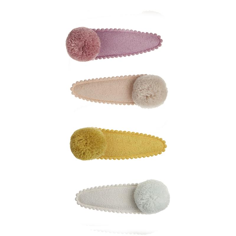 Mimi & Lula Pom Pom Mabel clips set of 4 in purple, beige, mustard, and pale blue.