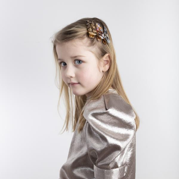 Mimi & Lula tortoise resin hair clips worn in a girl's hair (set of several)