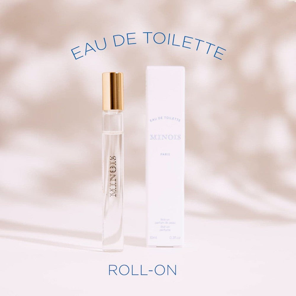 Minois Paris Eau de Toilette Roll-On 10 ml bottle with gold cap beside its white box