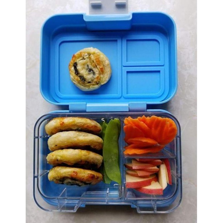 MUNCHBOX Munchi Snack Blue Storm lunch box set with mini sandwiches, snap peas, carrot curls, and apple slices.