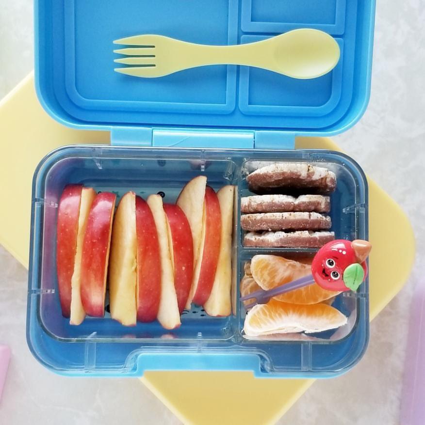 Munchbox Munchi Snack Blue Storm lunch box with apple slices, orange segments, cookies and a small red toy