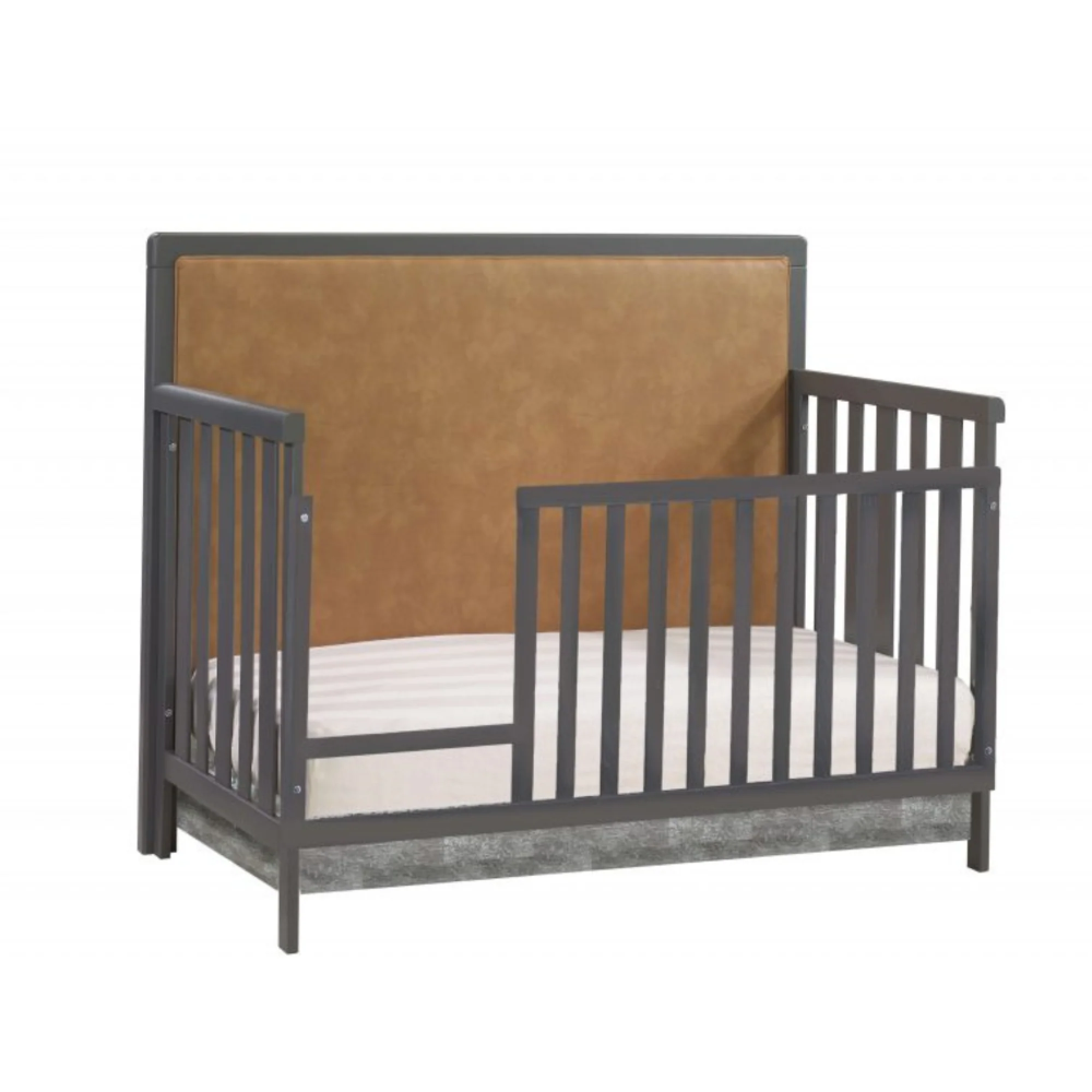 Natart Kyoto 5 In 1 Convertible Crib With Upholstered Panel Leather features gray frame and tan leather panel for stylish nursery setup.