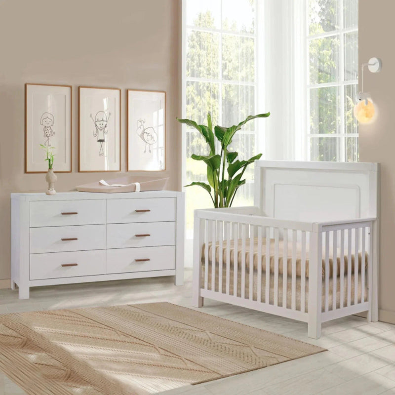 Natart Signature Series Toscano 66 Inch King Dresser in white with six drawers next to a white crib.