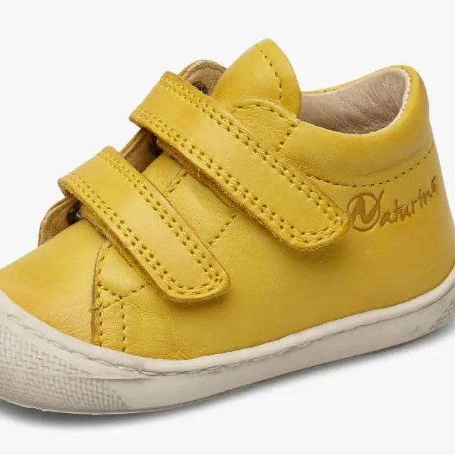 Naturino Cocoon Vl Yellow toddler shoe with two Velcro straps and white rubber sole