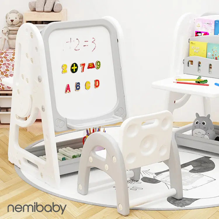 Nemibaby Multi Function Easel & Bookshelf in white/gray; child writes on the whiteboard while items store in shelves.