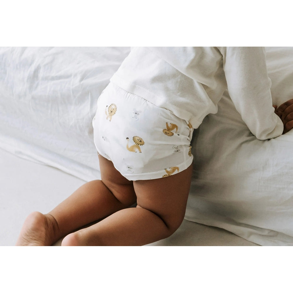Nest Design Bamboo Boys Boxer Briefs Underwear (2 Pack) Lion & Goose; toddler crawls on a white bed wearing printed white briefs.
