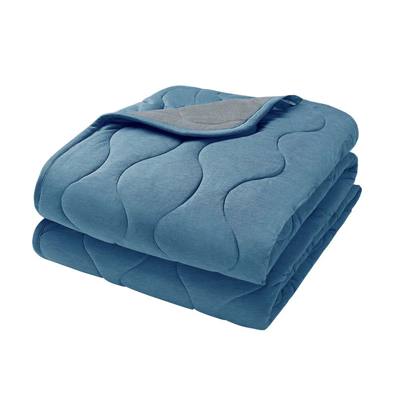 Nest Designs Avocado Bamboo Cozy Blanket Medium Captain's Blue, a folded blue quilted blanket highlighting soft bamboo fabric.