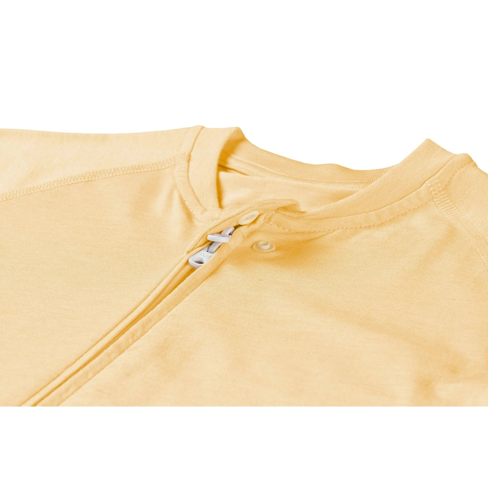 Nest Designs Bamboo Jersey Short Sleeve Footed Sleep Bag 0.5 TOG Pantone Sunset Gold, zipper opening reveals soft fabric.