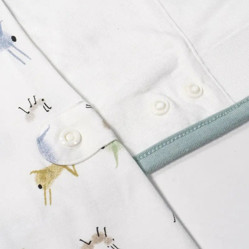 Nest Designs Bamboo Jersey Swaddle Sleep Bag 0.25 Tog The Ant & The Grasshopper, white with pale blue trim, 0–6M, snapped shut