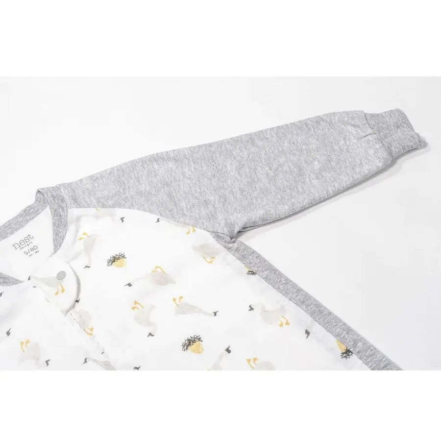 Nest Designs Bamboo Long Sleeve Footed Sleep Bag 1.0 Tog; white interior with goose print and grey trim sleeves, laid flat