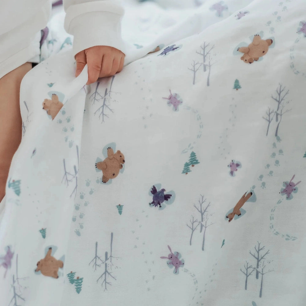 Nest Designs Bamboo Muslin Small Nesting Blanket 120cm x 120cm, white with bears and trees, baby hugs and wraps it.