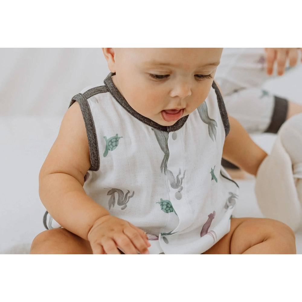 Nest Designs Bamboo Pima Sleeveless Button-Down Onesie The Tortoise & The Hare; white with charcoal trim, baby shows front snaps.