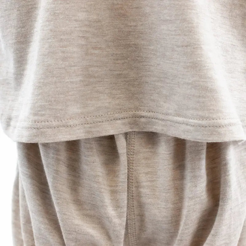 Nest Designs Basics Bamboo-Cotton Short Sleeve Drop Bottom Romper in warm taupe; soft knit fabric with visible drop-bottom panel.