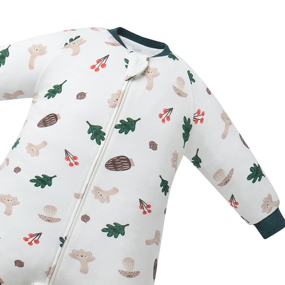 Nest Designs footed sleep bag in Forest Forage print, cotton white with green cuffs