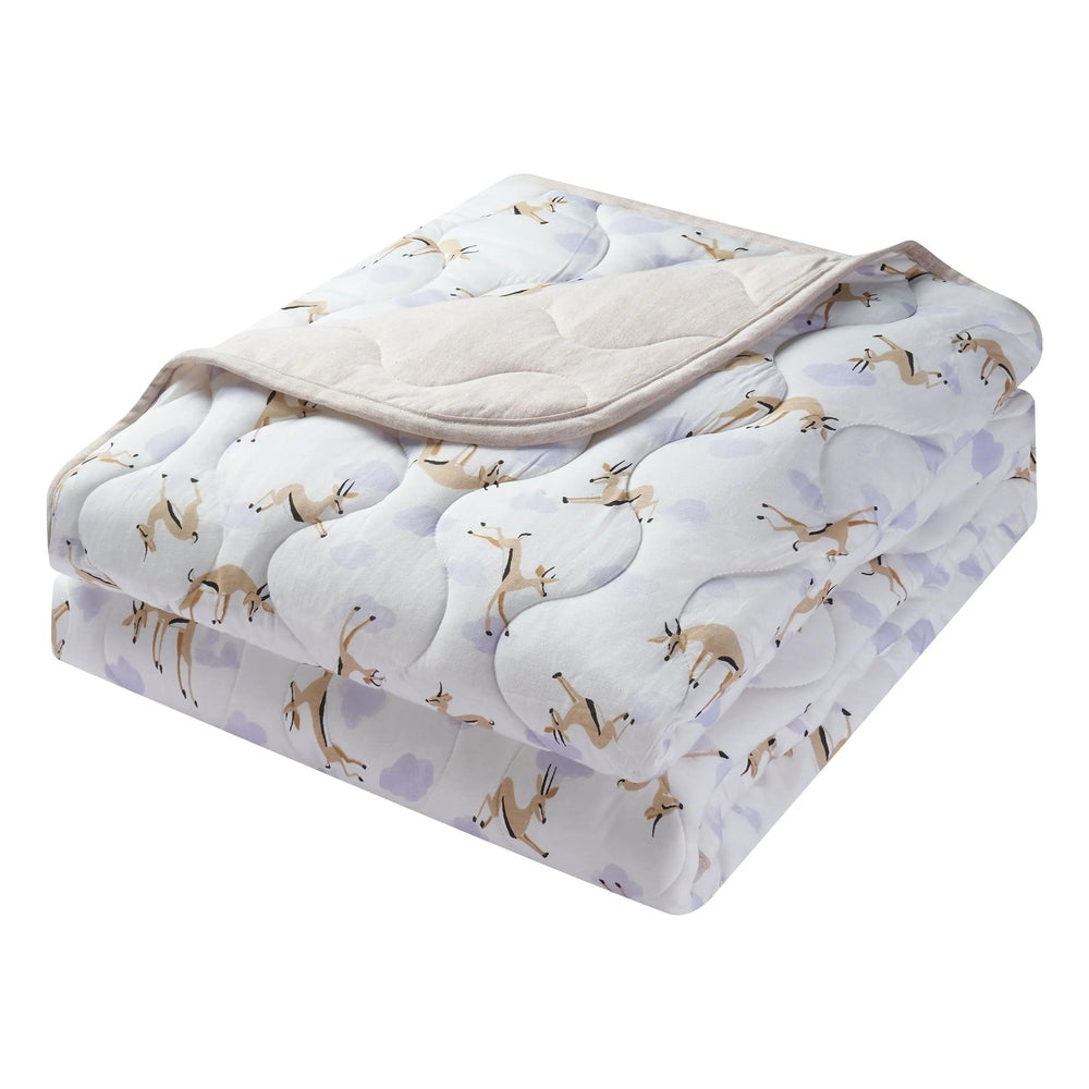 Nest Designs Quilted Bamboo Jersey Winter Blanket 3.2 Tog, large, white deer pattern folded to reveal plush underside.