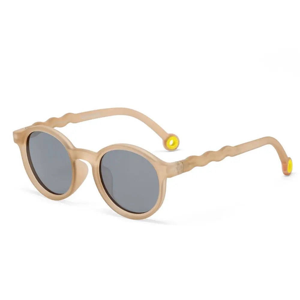 Olivio & Co Junior Oval Sunglasses in sand beige with grey lenses and yellow-tipped temples.