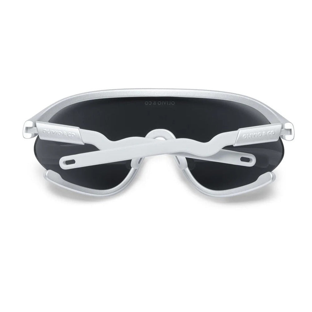 Olivio & Co Sport Sunglasses Kids full-rim Space Silver with dark lenses, arms crossed over the lenses.