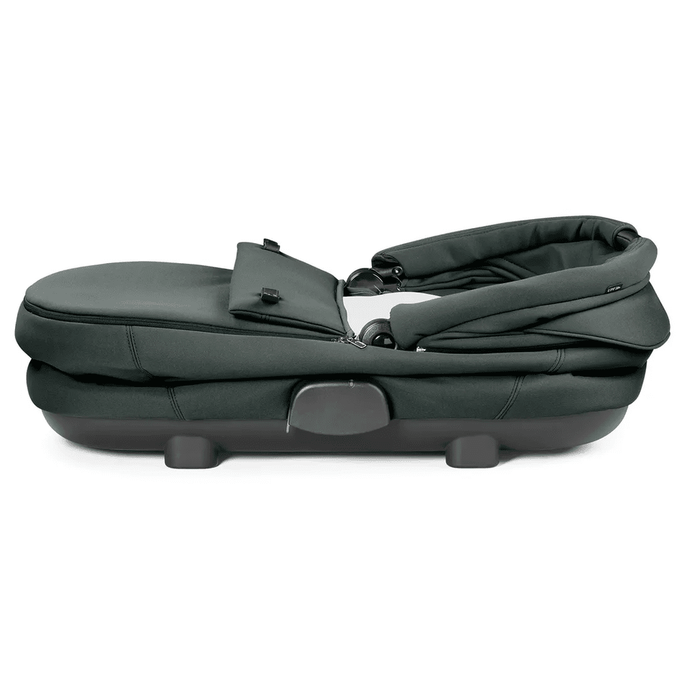 Peg Perego Culla Flex Bassinet with stand in dark green, cradle laid flat on a sturdy base for newborn comfort.