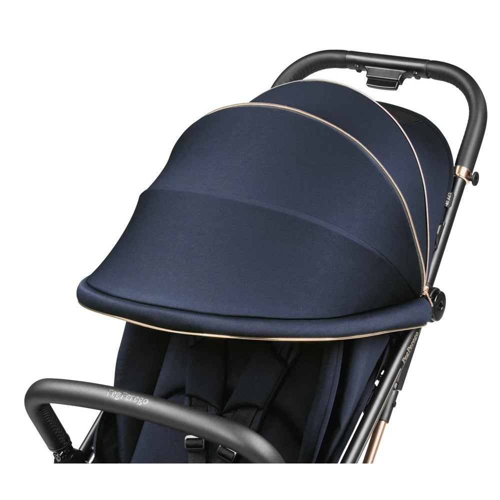 Peg Perego Selfie Plus Stroller in navy with rose-gold trim, showing extended canopy and ergonomic handle.