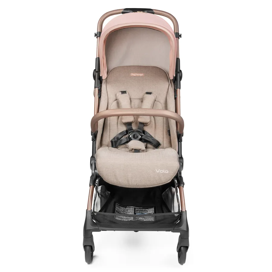 Peg Perego VOLO Travel Stroller in beige-pink with canopy, 5-point harness, and mesh storage basket.