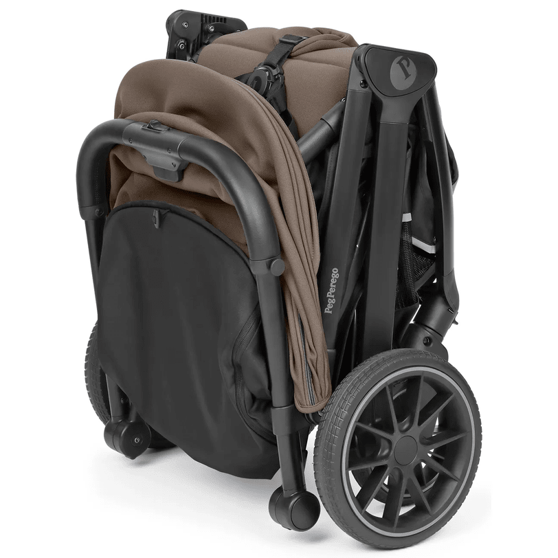 Peg Perego X-Country Travel Stroller folded compactly, brown fabric seat tucked, black frame and large wheels visible.