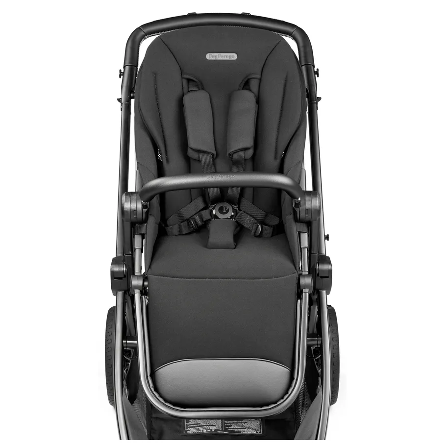 Peg Perego YPSI Stroller in black with padded seat, 5-point harness buckled, and front bumper bar.