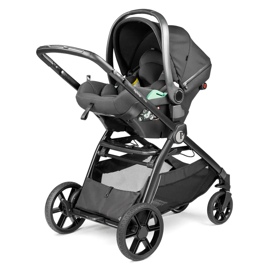 Peg Perego YPSI Stroller with bassinet attached, sturdy black frame, large wheels, and lower storage basket.