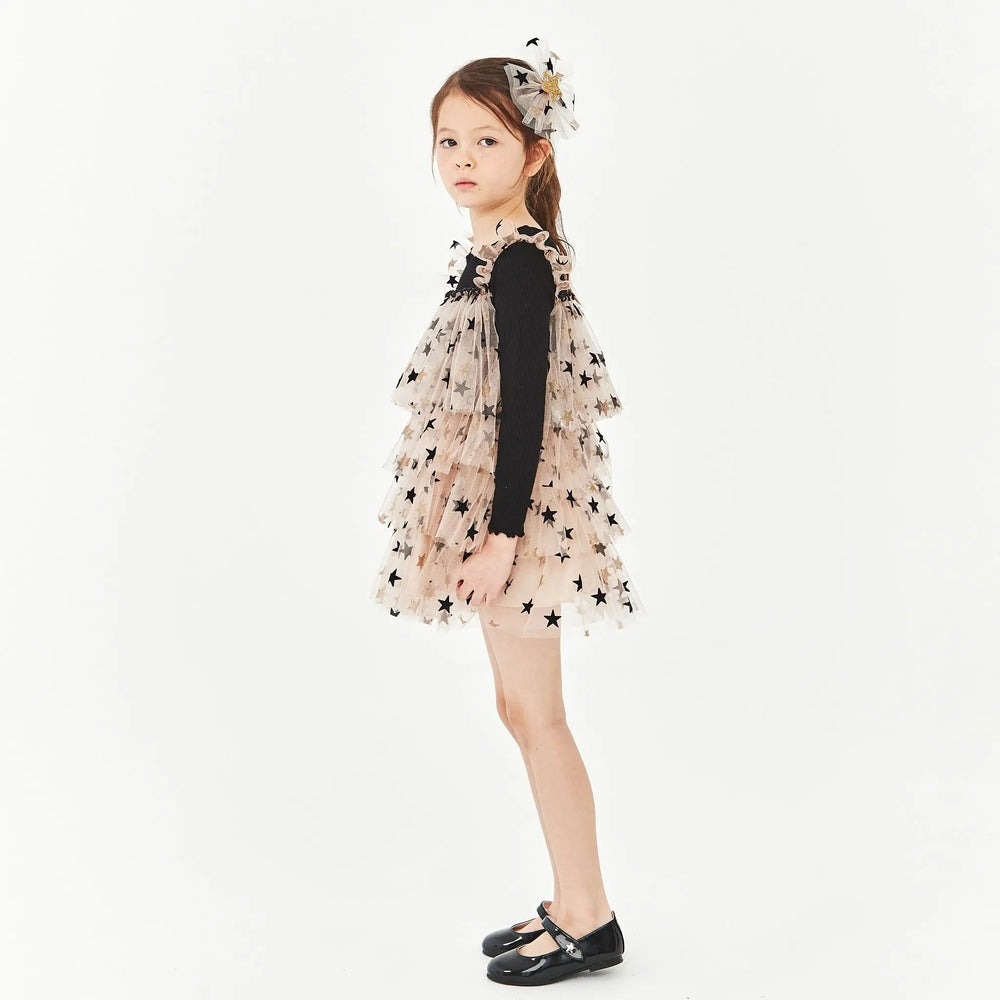 Petite Hailey Layered LS Tutu Black Star dress worn by a girl in a black top, beige star-tulle tutu with matching headpiece.
