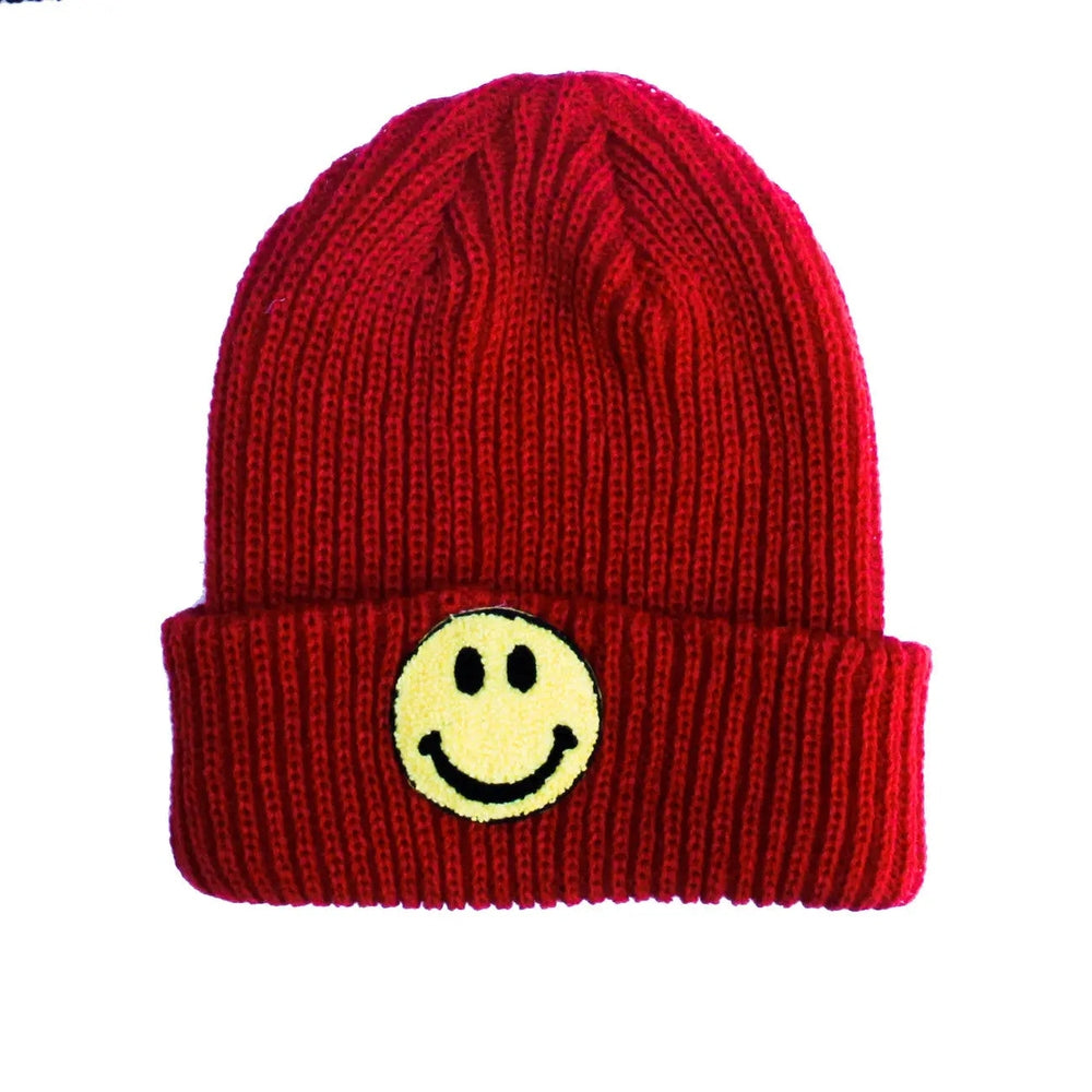 Petite Hailey Smile Beanie Red knit hat with a yellow smiley patch seen with a folded cuff.