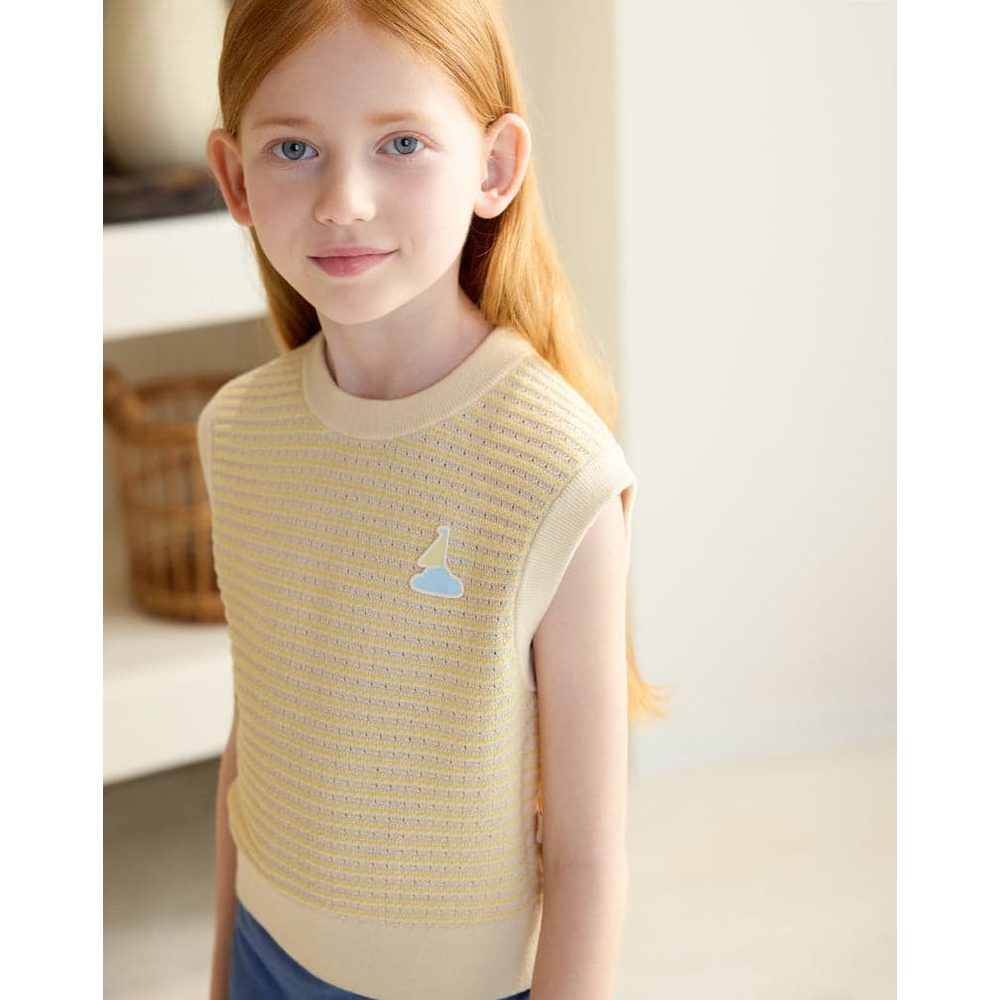 PETITE REVERY Cotton Knit Sleeveless Vest Mellow Yellow worn by a girl indoors, features striped knit and blue cloud pin.