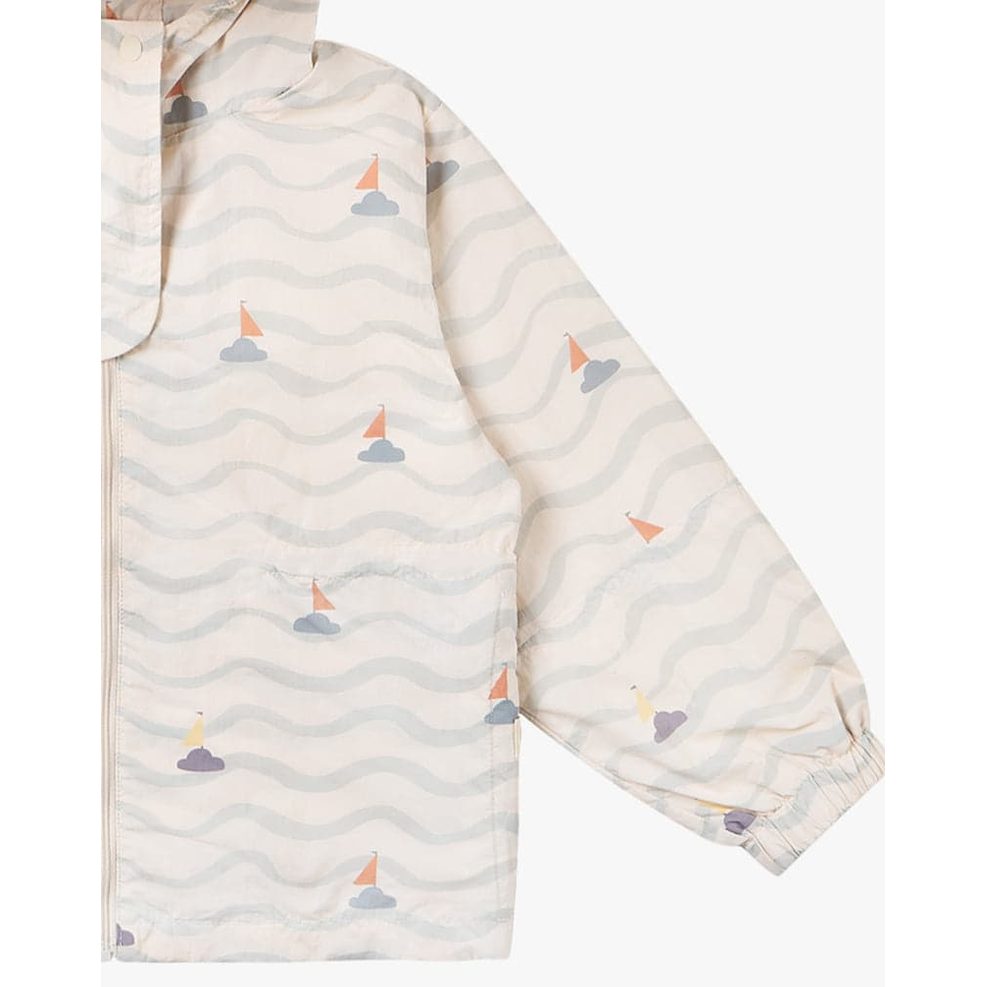 Petite Revery Hooded Windbreaker Sea La Vie cream jacket with pale blue waves and sailboats, front zipper visible.
