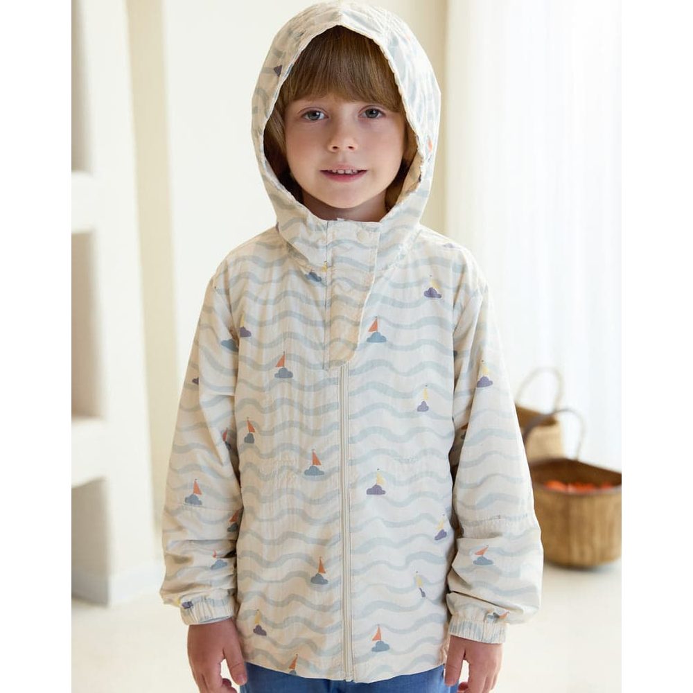 Petite Revery Hooded Windbreaker Sea La Vie worn by a child indoors; pastel zip-up jacket with hood.