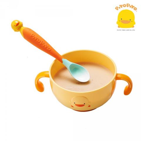 PIYO PIYO Magic Bendies spoon & fork set: yellow duck-face bowl with teal spoon scooping creamy porridge.