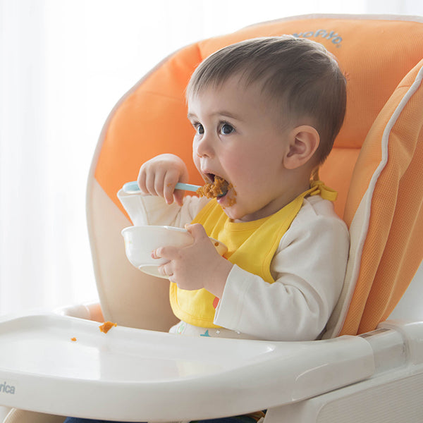 Piyo Piyo silicone spoon blue/orange for babies; feeding utensil in a high chair.