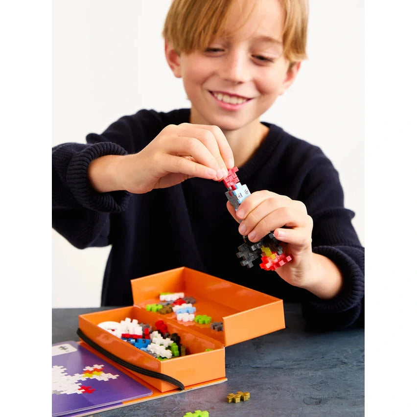 Plus-Plus Space 125-piece building toy set with colorful interlocking blocks and orange storage box