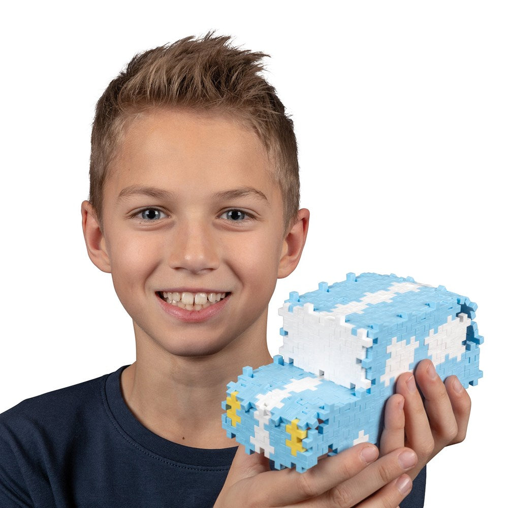 Plus-Plus Metal Suitcase Pastel 600pcs building toy with blue and white bricks forming a cube vehicle by PLUS-PLUS